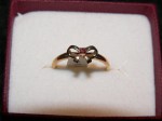 Ladies 9ct gold ring with red stone bow design. Click for more information...