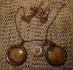 Old silver necklace with 2 kids photographs and St Christopher medallion. Click for more information...